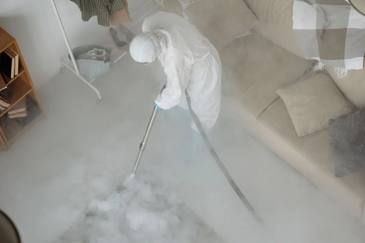Biohazard cleanup technician in protective equipment, Heidelberg, TX